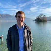 Student standing in front of lake