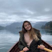 Student rowing a boat on lake