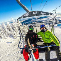 Snowboarders on a lift