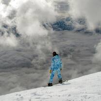 Lone Snowboarder on edge of drop with horizon
