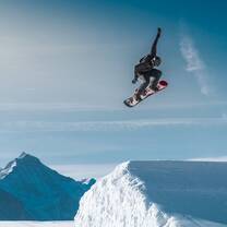 Snowboarder on Terrain park, catching airtime