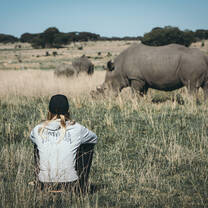 Girl sitting down watching rhino