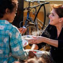 Volunteer helping with breakfast programme at community project in Cambodia