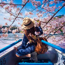 Girl in boat with cherry blossoms