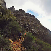 student hiking on a mountain trail