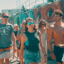 A group of people walking through Sydney's streets filled with street art