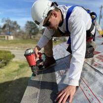 Volunteer nailing shingles