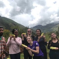 group holding corn humitas in Peru