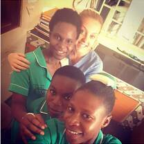 A medical volunteer having fun with Ugandan nurses after work