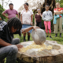 Students learning how to make grind maiz in Costa Rica