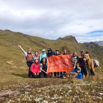 Hiking and celebrating in the Sacred Valley group of Operation Groundswell travellers with the OG flag