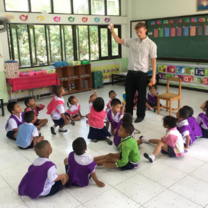 TEFL teacher with students sat on floor