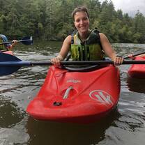Students learning the basics of whitewater kayaking at Wolfe Lake on camp property