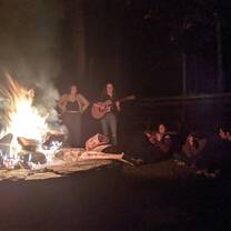Guitar performances by students at campfire