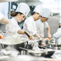 Students in the kitchen during Cuisine Diploma program at Le Cordon Bleu