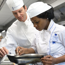 Students in the kitchen during Cuisine Diploma program at Le Cordon Bleu