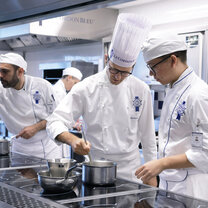 Students in the kitchen during Cuisine Diploma program at Le Cordon Bleu