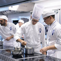 Students in the kitchen during Cuisine Diploma program at Le Cordon Bleu