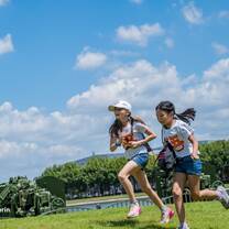 Campers run in the Park of Oriental Land