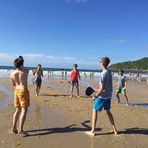 Horizons Abroad summer Spanish immersion students play games together on the beach in San Sebastian