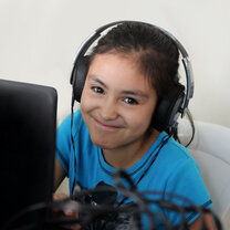 student with headset on at desk