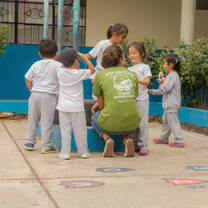 Projects Abroad volunteer talks with local children on a Childcare project in the Galapagos Islands, Ecuador