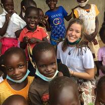 a volunteer very happy with the orphans and vulnerable children.
