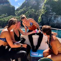 Interns conduct water quality sampling on the boat