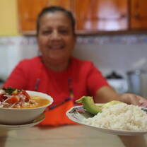 A Projects Abroad Host Mom presents a traditional, home-cooked meal