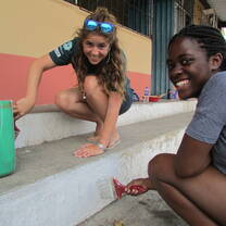 Two Projects Abroad volunteers in Ecuador having fun working to update a local school 