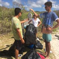 Projects Abroad volunteers weigh the trash the found during a clean-up