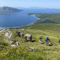 Volunteers trekking by a beautiful serene lake