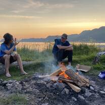 Volunteers relaxing by a warming camp fire