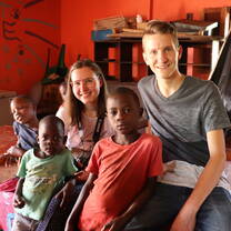 Volunteers and children in the dining room