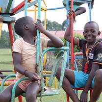 Children playing with a carrousel at the playground