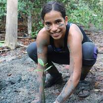 Girl planting plants in Costa Rica