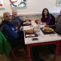 Students and teachers eating Cocido in a restaurant