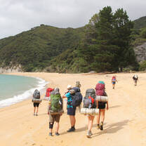 Students backpacking on a beach