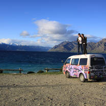 People standing on top of an adventure van in New Zealand