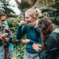 students tasting local food