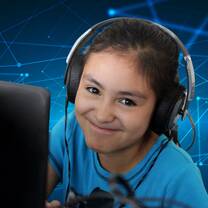 happy young girl at computer wearing big headphones