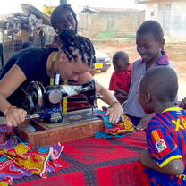 A student learning traditional sewing techniques in Ghana