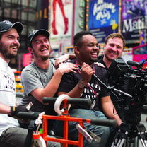 Man holds camera in Times Square