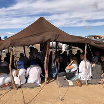 Under a tent in the desert
