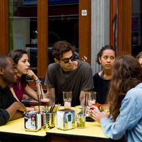 Students seated at an outdoor cafe table