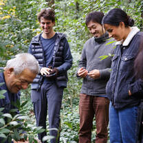 Students smile surrounded by greenery