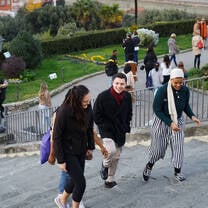 A group of students climb stone steps