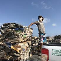 Staff member doing a beach clean-up
