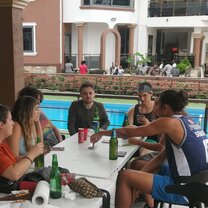 Volunteers spending their time playing cards at the poolside