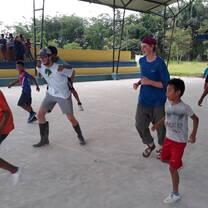 students playing soccer with children